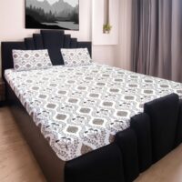 8IbL6qMij2kVc-CGRpthaf3r.jpg King size bedsheet with botanical print and two matching pillow covers on a black bed frame