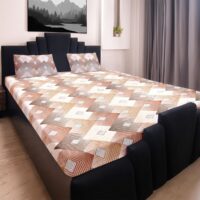 x1MYWwoZN3qVFsY4STpxSQch.jpg King size bedsheet with brown, beige, and white geometric pattern, with two matching pillow covers on a black bed frame.